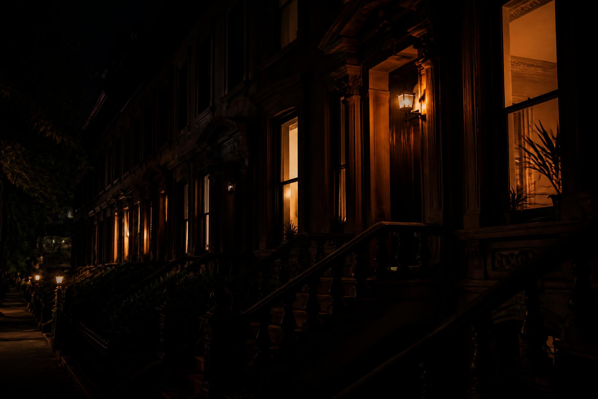 Brooklyn brownstones at dusk with warm lit windows